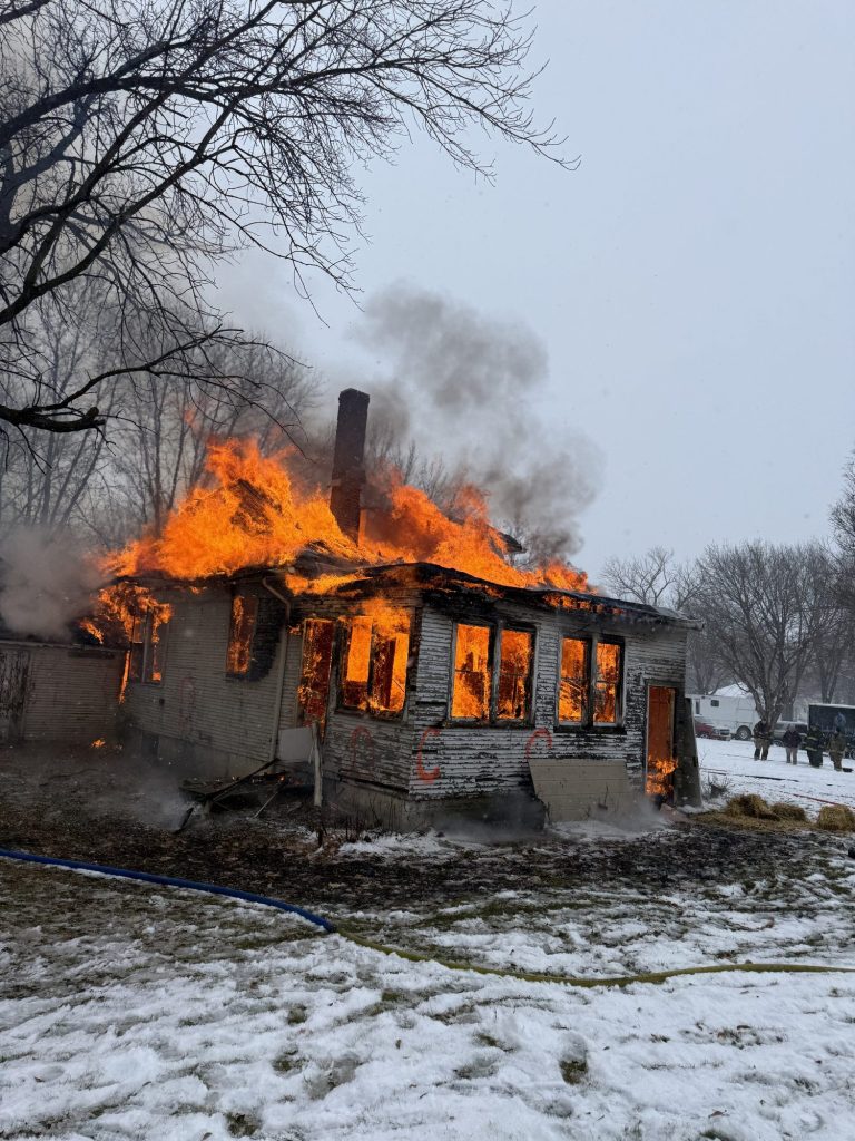 Fully involved house in the snow during an acquired structure burn