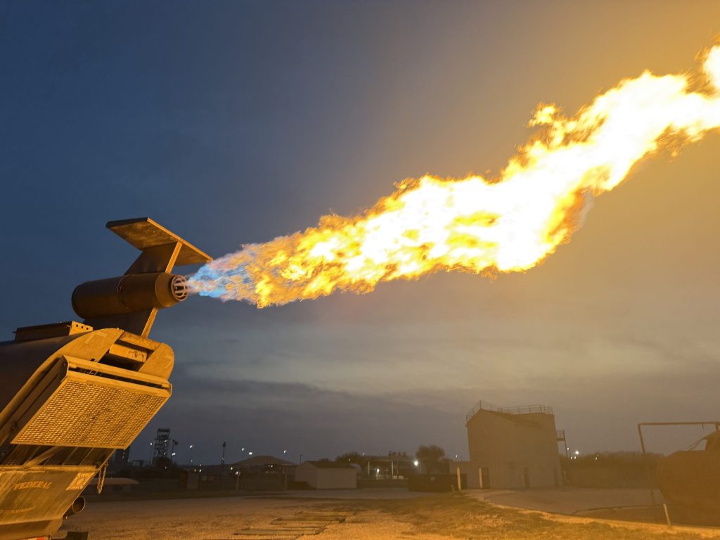 Flames from an aircraft engine fire prop at dusk