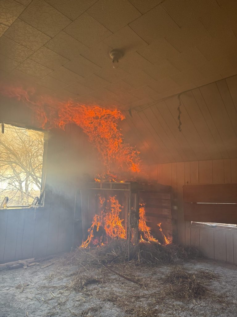 Fire growing up the wall of a burn room during live-fire training