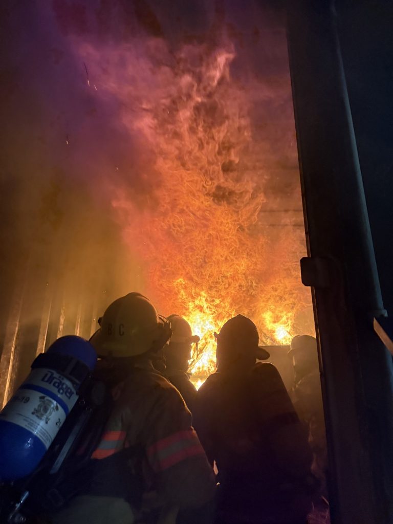 Firefighters on SCBA making an interior attack in a fire trainer