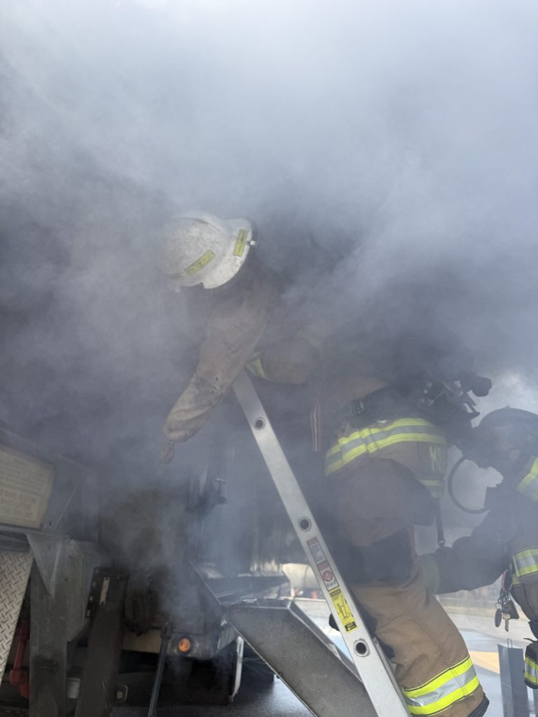 Firefighters working in heavy smoke on aircraft stairs