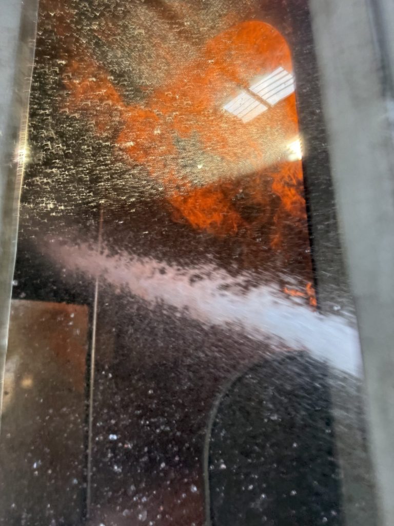 Hose stream hitting fire inside an aircraft fuselage trainer