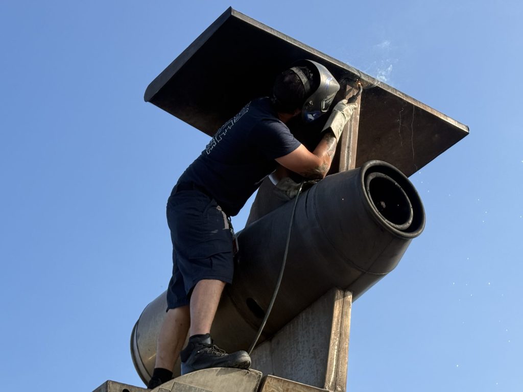 Instructor working on an aircraft engine fire prop at a live-fire training site