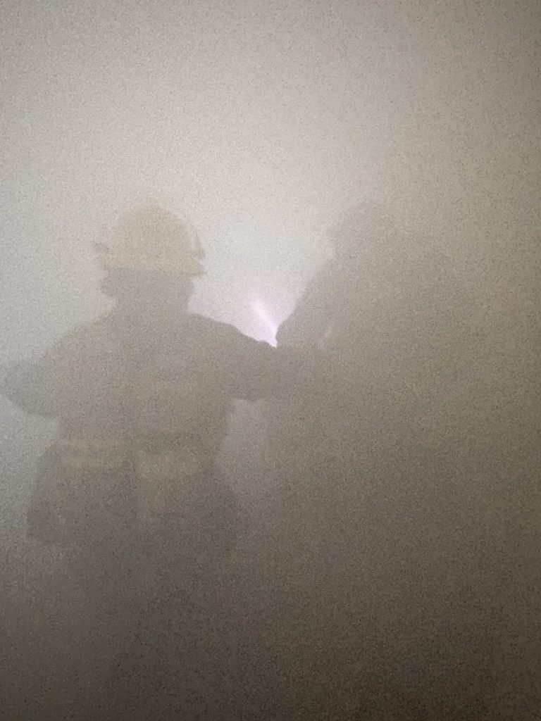 Firefighters advancing in zero-visibility smoke