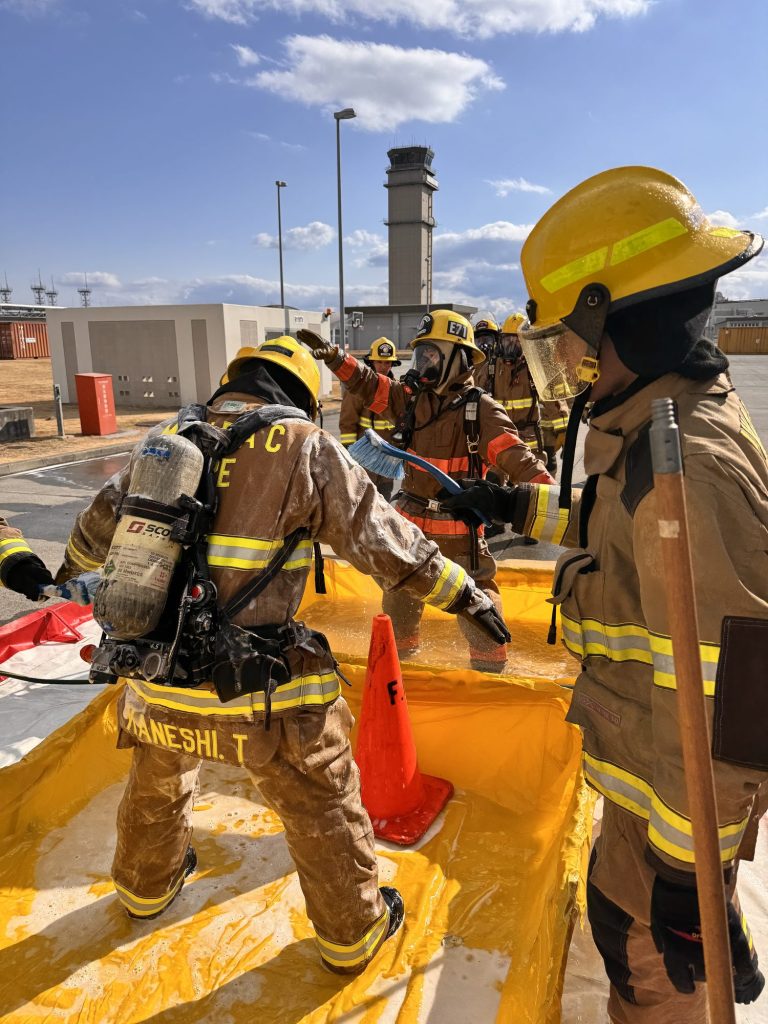 Firefighters on air working through a hazmat decontamination pool
