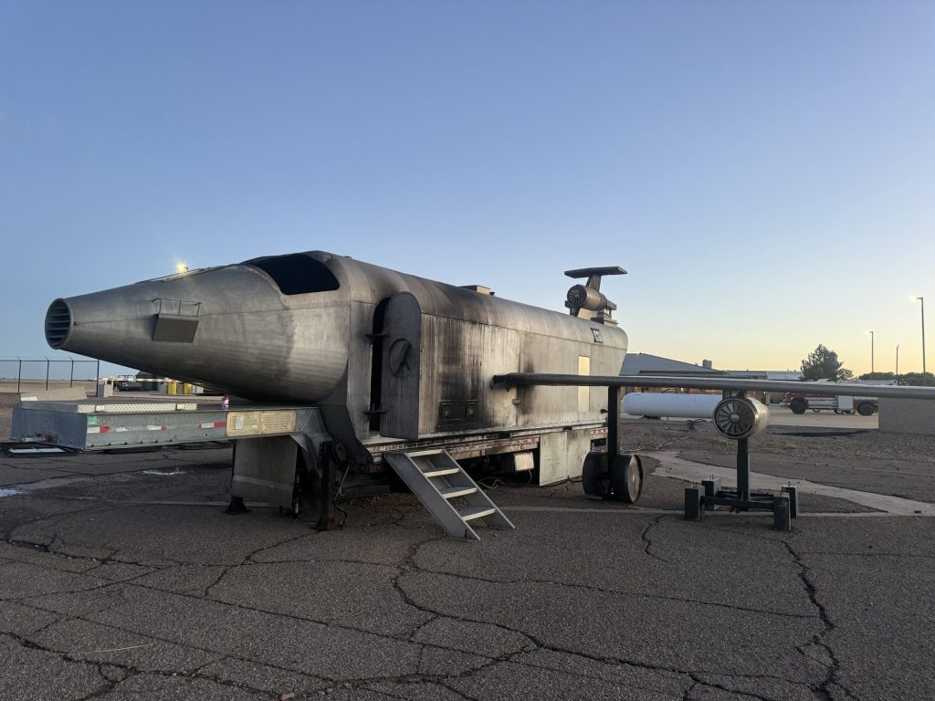 Mobile aircraft fire trainer set up on the ramp at dawn