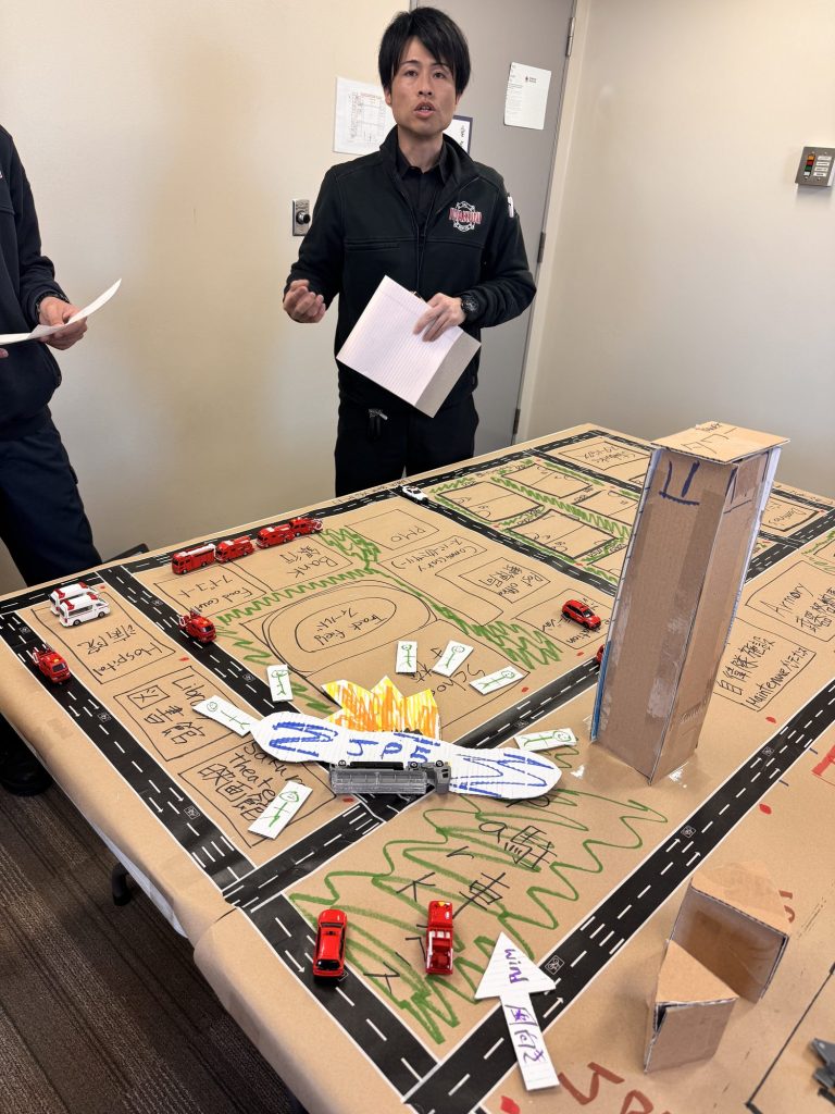 Instructor running a tabletop emergency exercise on an airport model